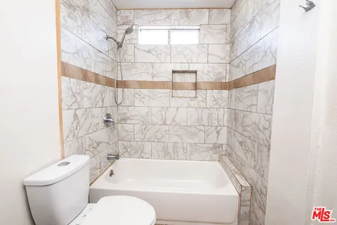 a bathroom with a toilet and bathtub