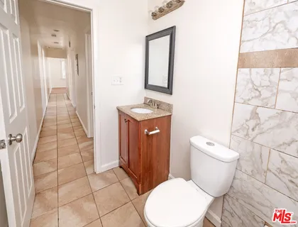 a white toilet sitting next to a bathroom sink