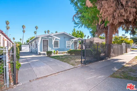 a view of a house with a yard and tree s