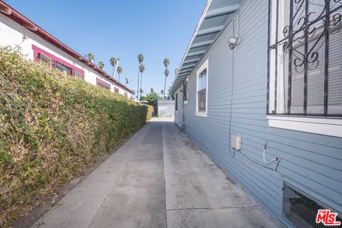 a view of a pathway both side of house