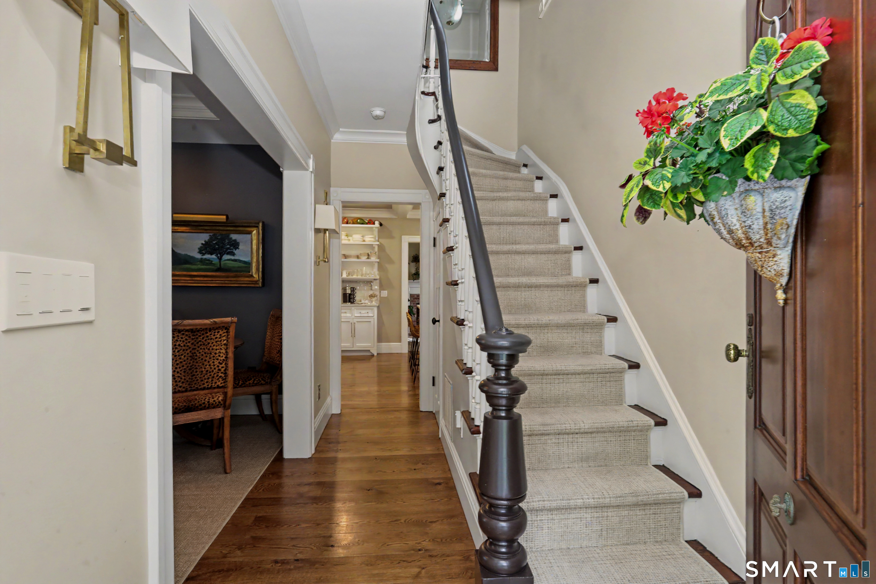 36 Catoonah Street, Unit 18 Ridgefield, CT 06877 - Photo 7 of 40 a view of staircase with wooden floor and a potted plant