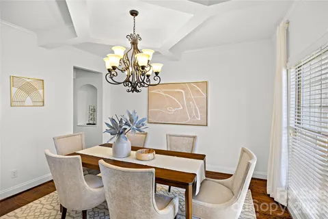 a dining room with furniture and chandelier