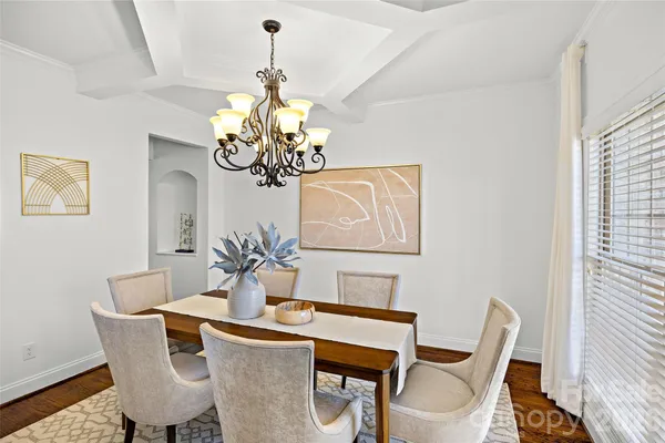 a dining room with furniture and chandelier