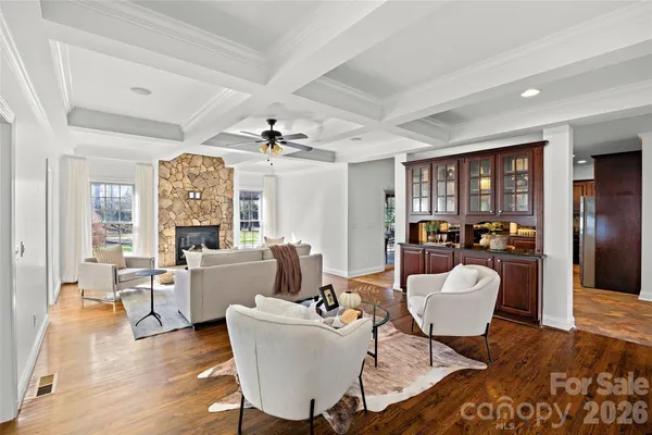 a living room with furniture a dining table and a fireplace