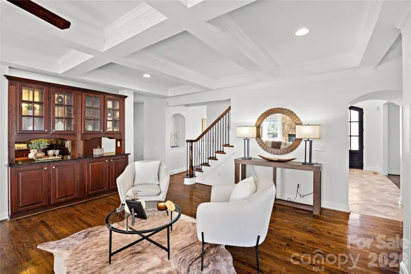 a living room with furniture a rug and a large window