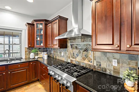 a kitchen with stainless steel appliances granite countertop a stove and a sink
