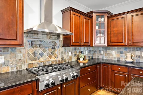a kitchen with stainless steel appliances granite countertop a stove and a sink