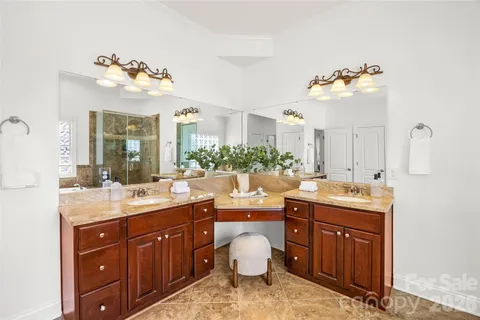 a bathroom with a double vanity sink and a mirror