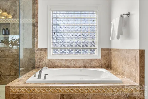 a bathroom with bathtub shower and a sink