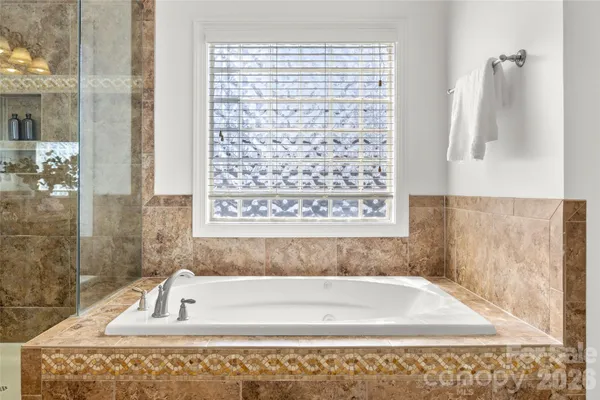 a bathroom with bathtub shower and a sink