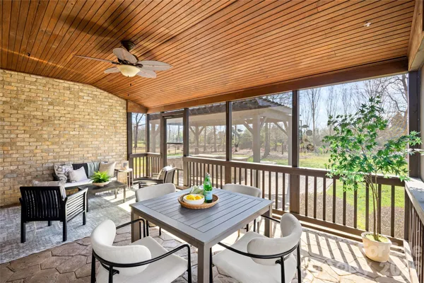 a view of a patio with a table and chairs
