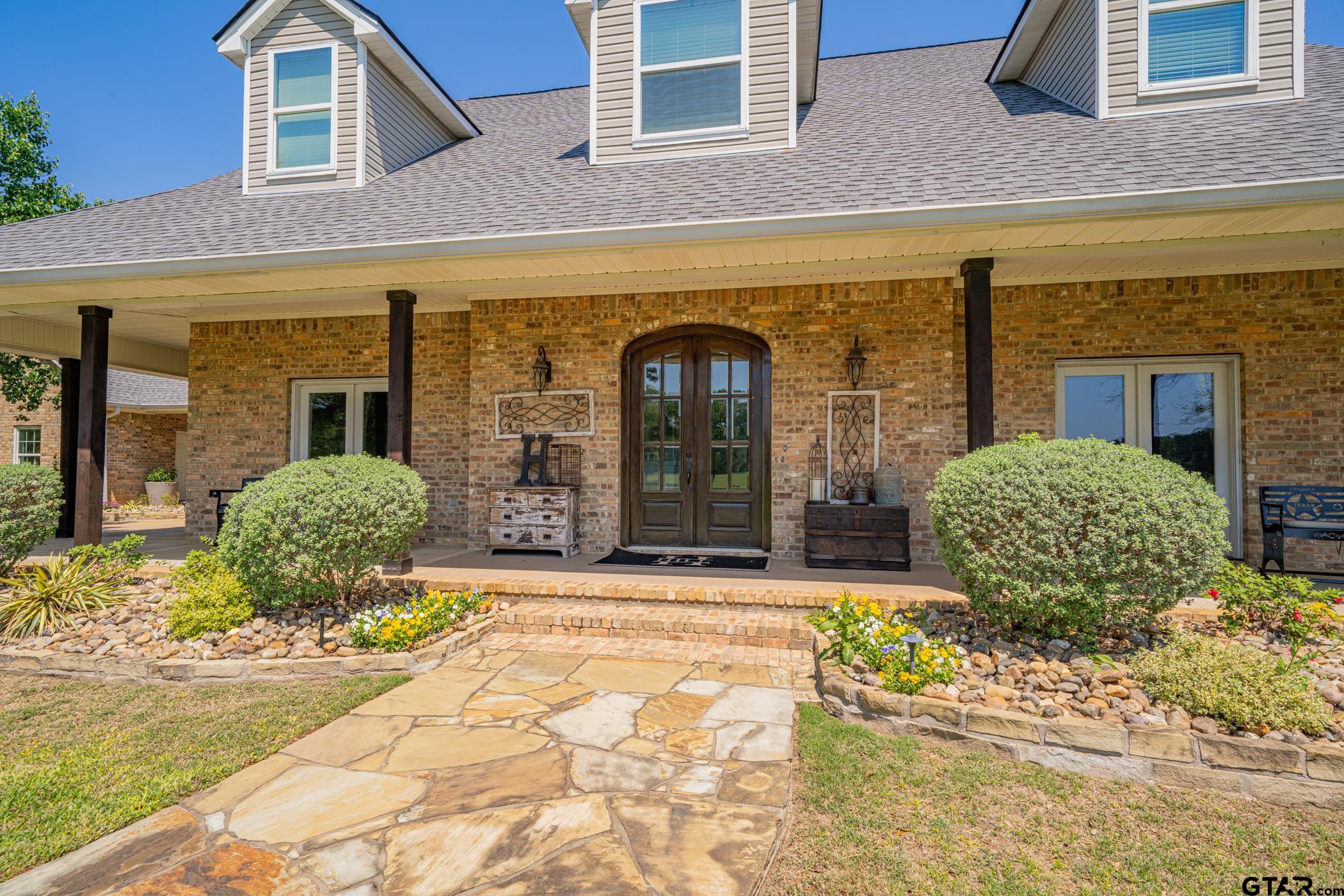 19980 FM 449 Longview, TX 75605 - Photo 2 of 48 a front view of a house with garden