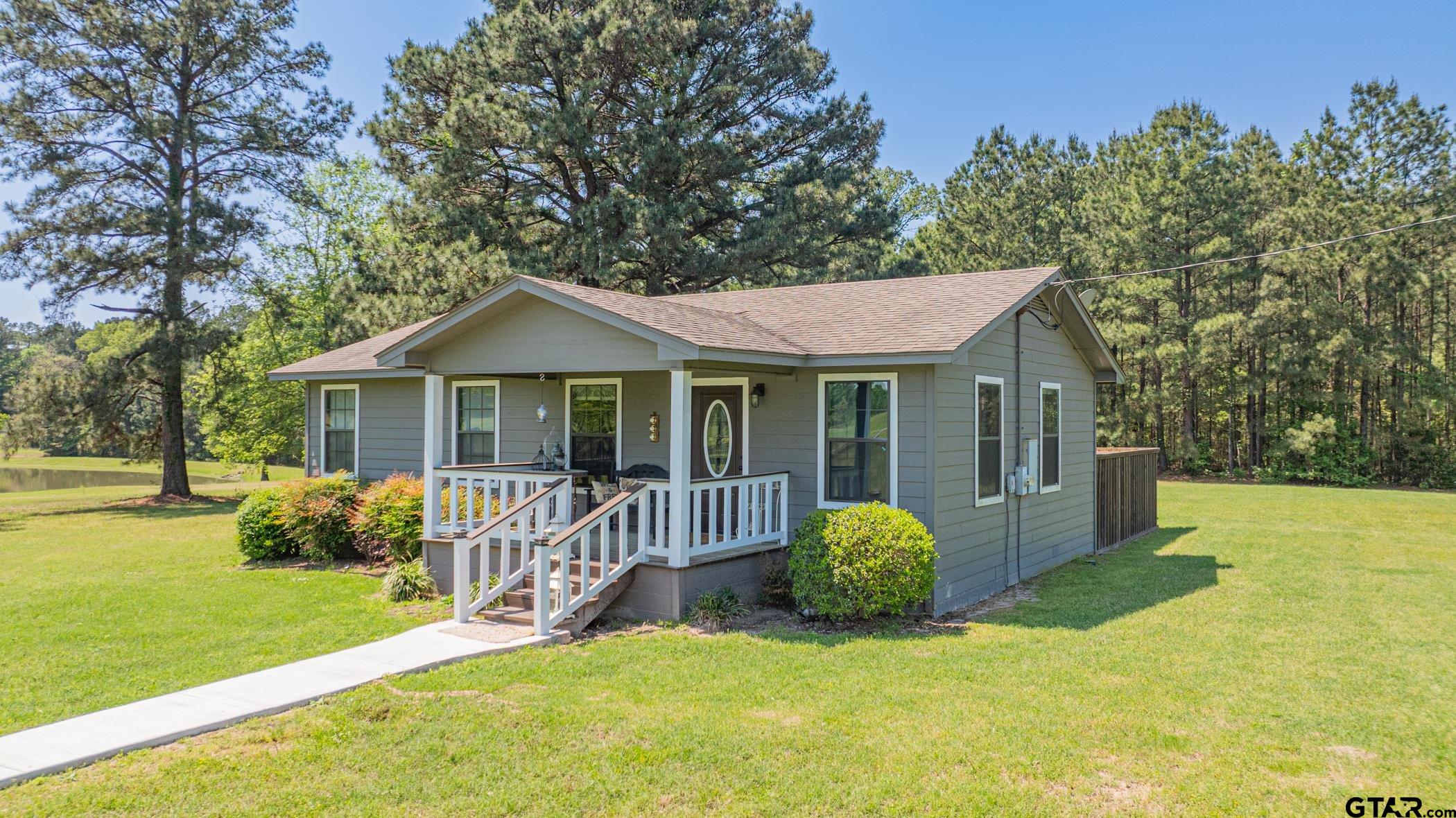 19980 FM 449 Longview, TX 75605 - Photo 31 of 48 a view of a house with a yard and a garden