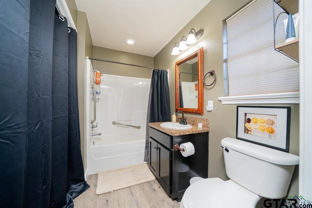 19980 FM 449 Longview, TX 75605 - Photo 35 of 48 a bathroom with a toilet a sink and a mirror