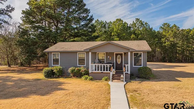a kitchen with granite countertop white cabinets and stainless steel appliances