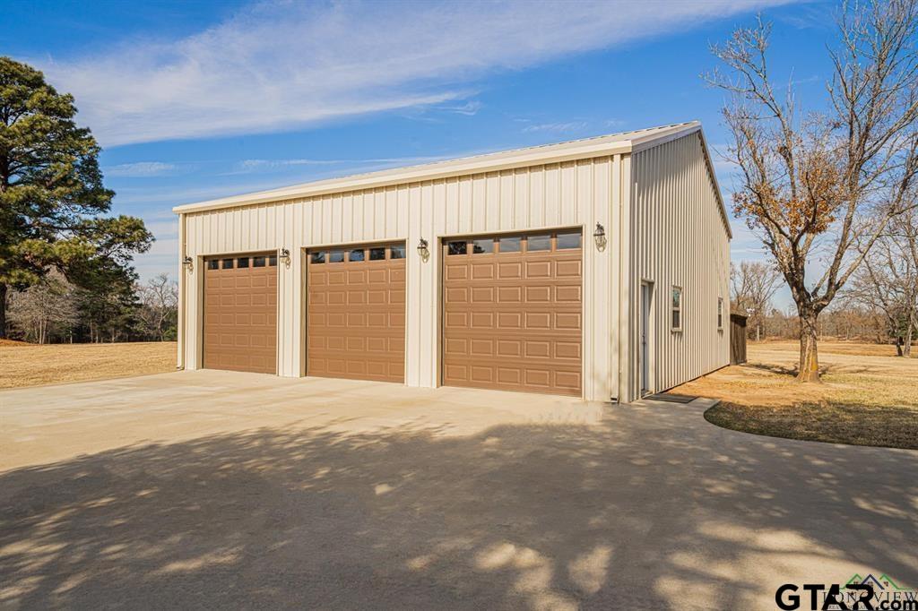 19980 FM 449 Longview, TX 75605 - Photo 41 of 48 a front view of a house with a garage