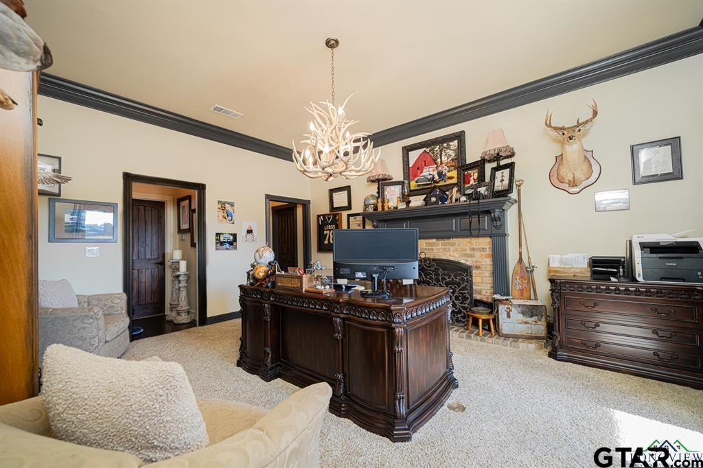 19980 FM 449 Longview, TX 75605 - Photo 9 of 48 a living room with furniture a fireplace and a chandelier
