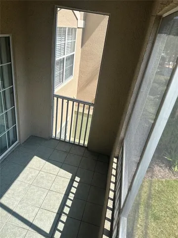 a view of room with window ceiling fan and hardwood floor