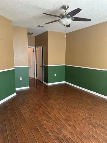 a view of a room with wooden floor