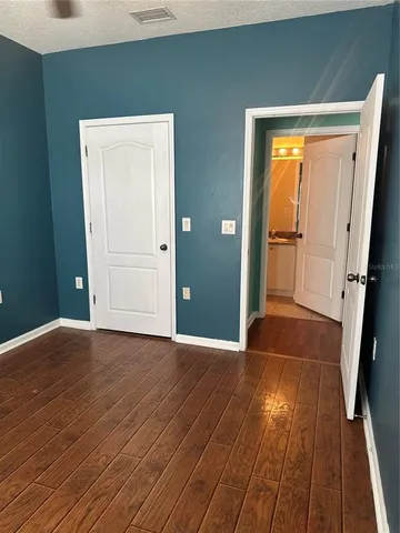 a view of house with outdoor space and tree in front