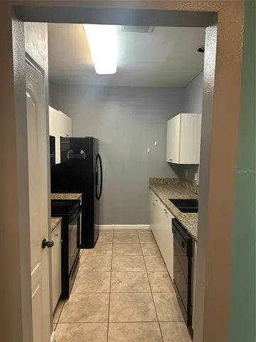 a kitchen with a stove and a refrigerator