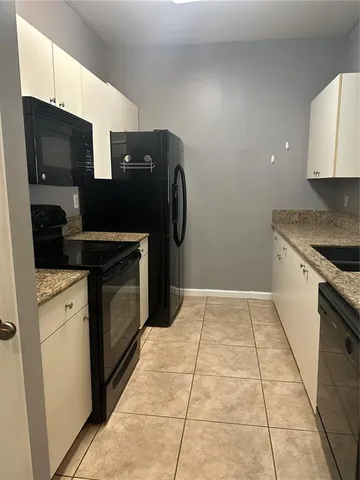 a kitchen with sink and cabinets