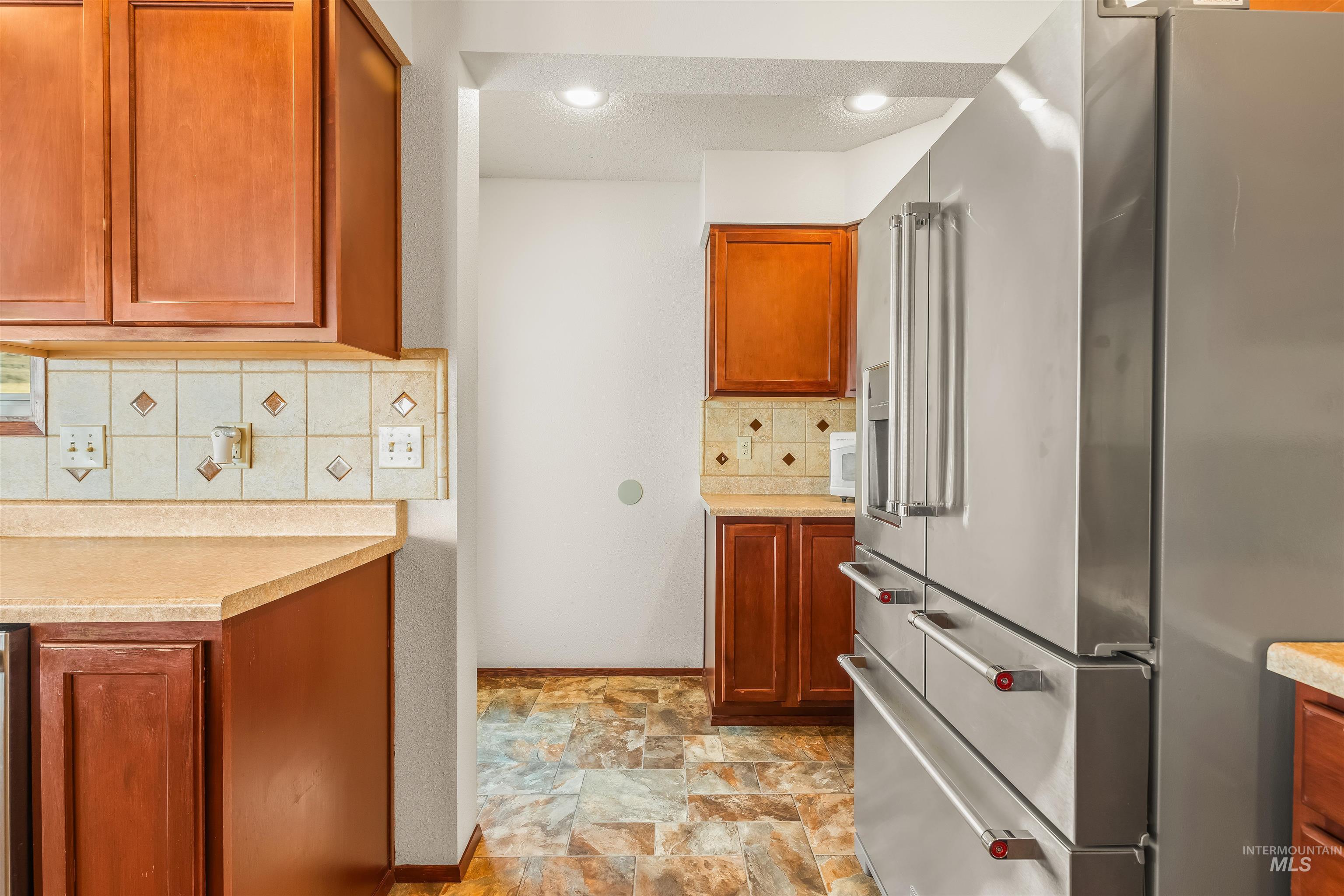 1133 Harvest Road Lewiston, ID 83501 - Photo 20 of 45 Contemporary kitchen featuring a stainless steel refrigerator, recessed lighting, and wood cabinetry