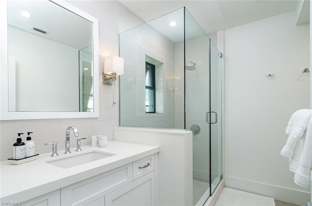 930 9th Street South, Unit 930 Naples, FL 34102 - Photo 14 of 17 a bathroom with a sink vanity and a mirror