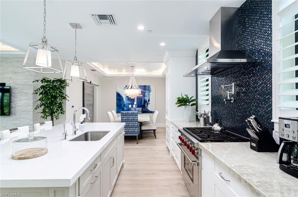 930 9th Street South, Unit 930 Naples, FL 34102 - Photo 4 of 17 a kitchen with stove and cabinets