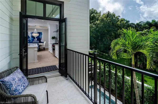 a balcony with furniture and a potted plant