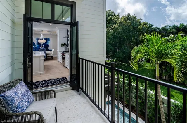 a balcony with furniture and a potted plant