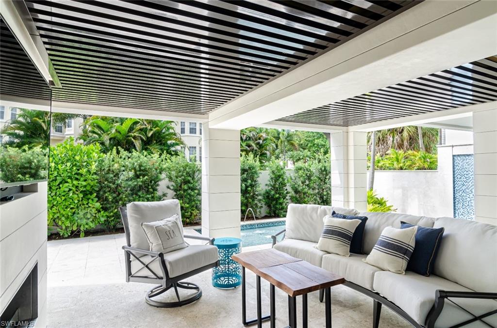 930 9th Street South, Unit 930 Naples, FL 34102 - Photo 7 of 17 a balcony with furniture and a potted plant