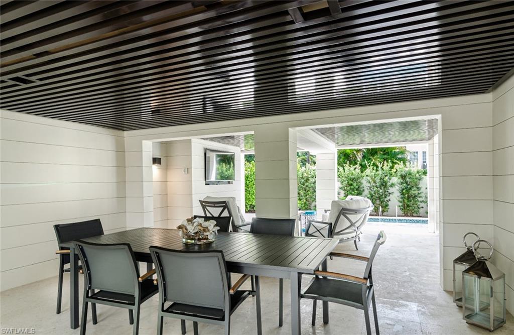 930 9th Street South, Unit 930 Naples, FL 34102 - Photo 8 of 17 a view of a room that has a table and chairs in it