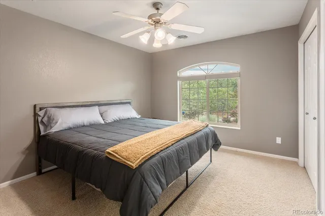 a bedroom with a large bed and a chandelier