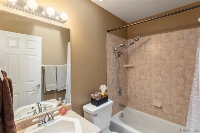 a bathroom with a sink mirror toilet and bathtub