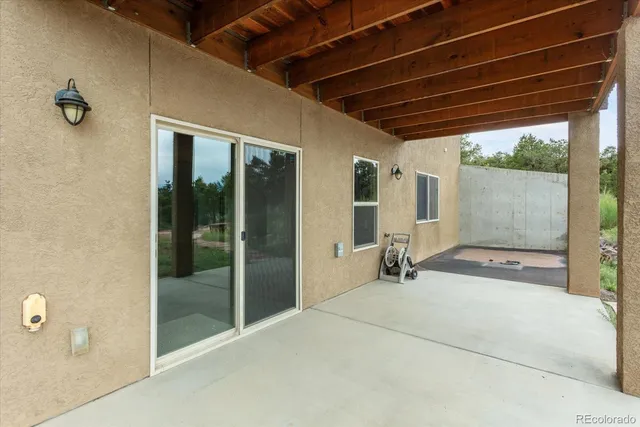 a view of a room with wooden floor and windows