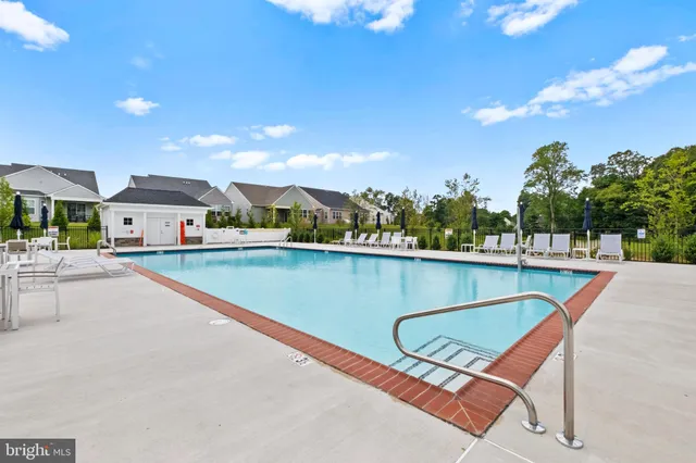 a view of swimming pool with a lounge chairs