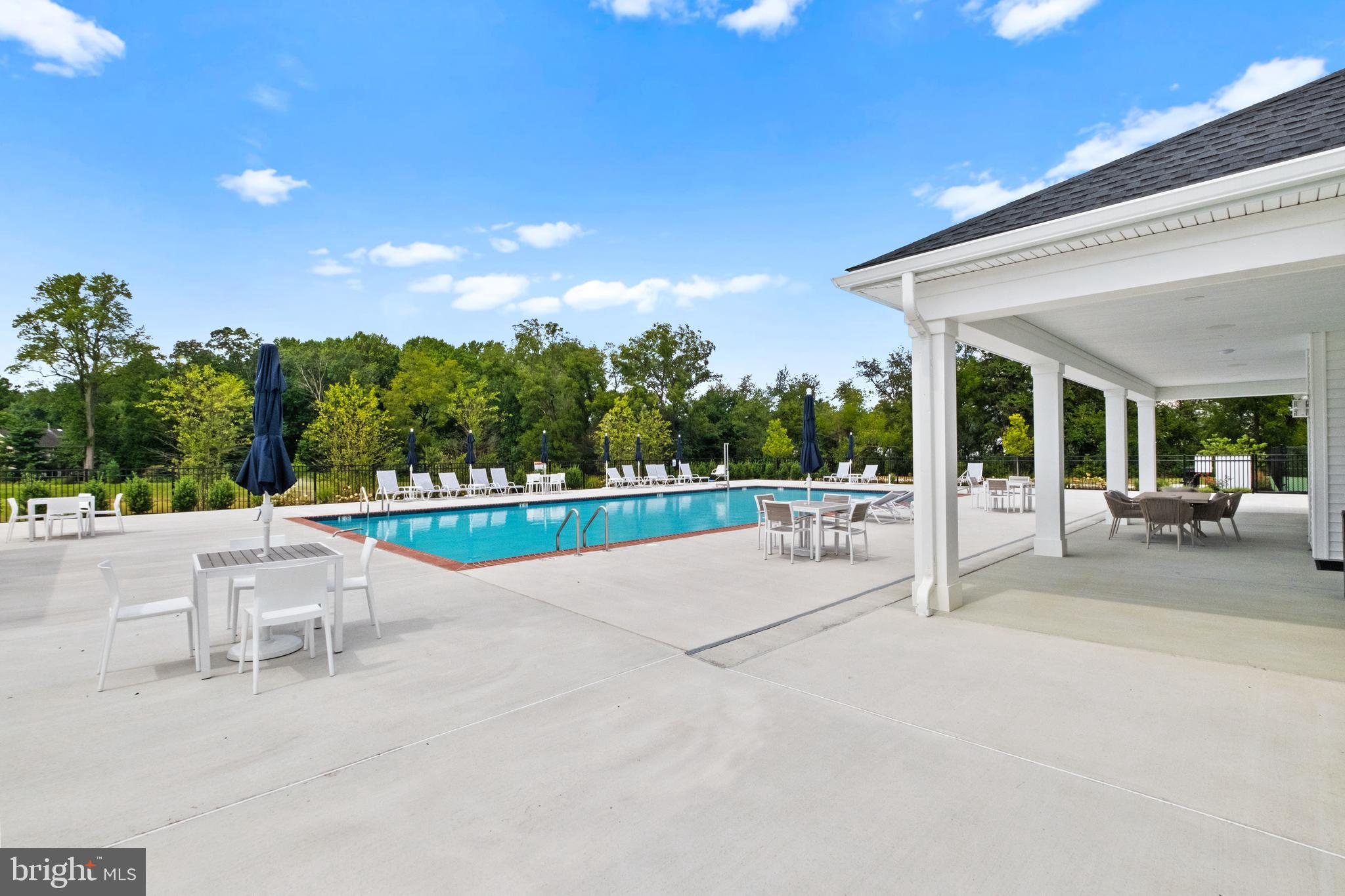 0 Messina Loop Loop Mullica Hill, NJ 08062 - Photo 18 of 35 a view of a patio with table and chairs potted plants with floor to ceiling window