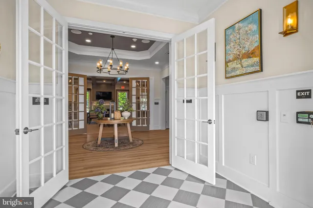 a view of a dining room with furniture and chandelier
