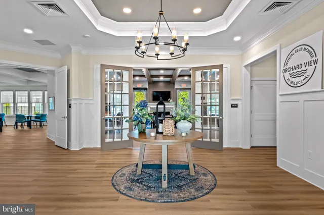 a view of a dining room with furniture wooden floor and chandelier