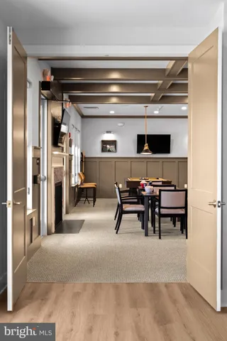 a view of dining room with furniture and a fireplace