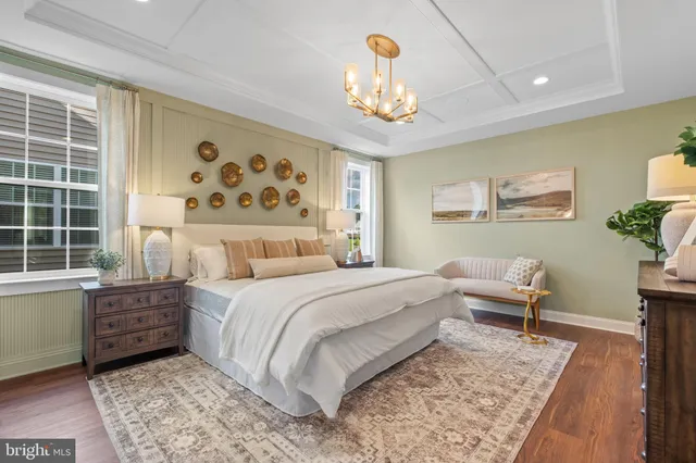 a spacious bedroom with a bed and a chandelier