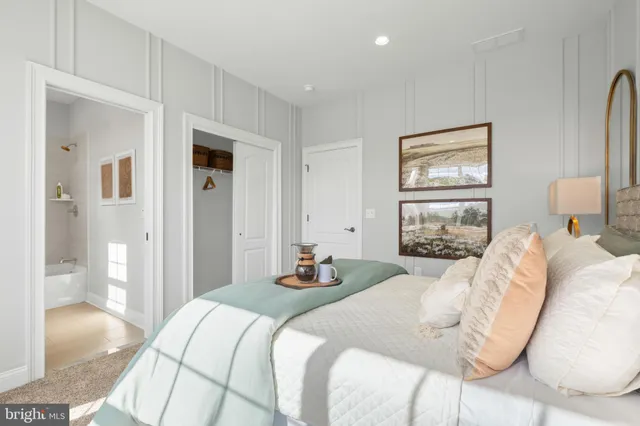 a bedroom with a bed and a painting