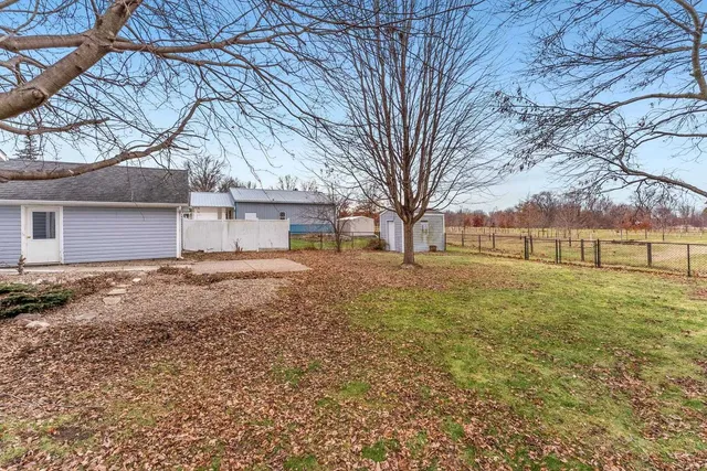 a view of a yard with a house and a road