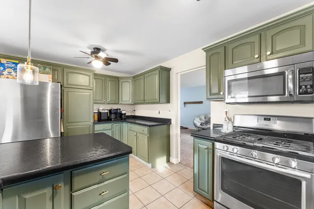 a kitchen with a sink stainless steel appliances and cabinets