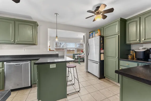 a kitchen with a refrigerator a sink and cabinets