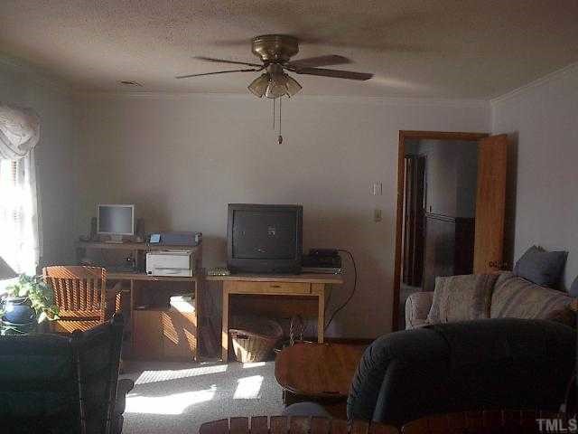 3949 Highway 42 Raleigh, NC 27603 - Photo 6 of 12 a living room with furniture and a flat screen tv