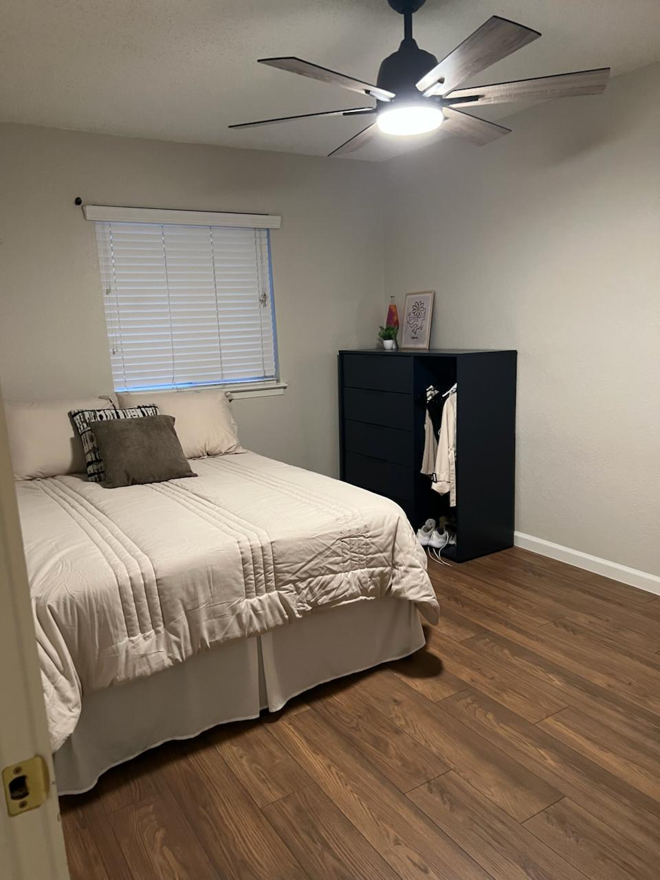 2401 Manor St Road, Unit 118 Austin, TX 78722 - Photo 12 of 17 a bedroom with a bed and wooden floor