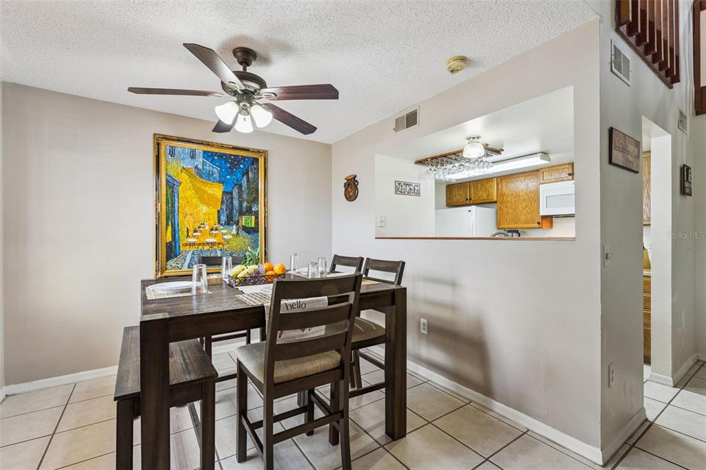 1017 Monroe Avenue St. Cloud, FL 34769 - Photo 12 of 53 a view of a dining room with furniture and a chandelier fan