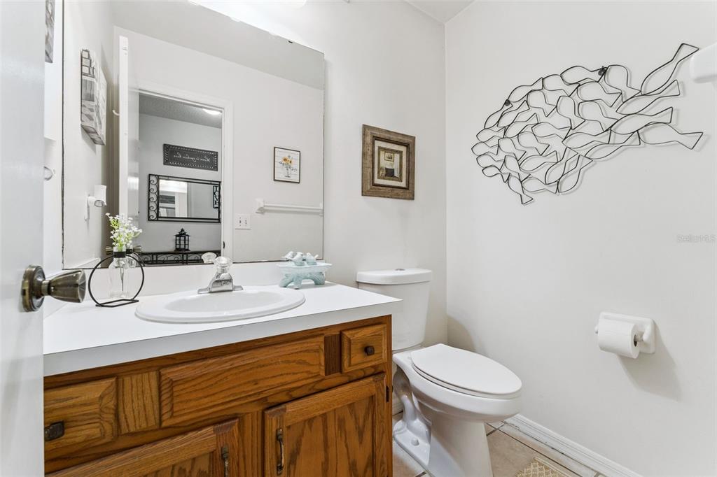1017 Monroe Avenue St. Cloud, FL 34769 - Photo 14 of 53 a bathroom with a toilet sink and mirror